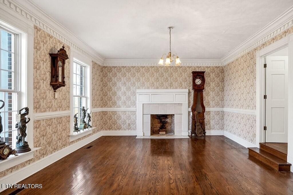 6211 Rocky Point Road Cookeville, TN 38506 - Photo 24 of 59 a view of an empty room with wooden floor fireplace and a window