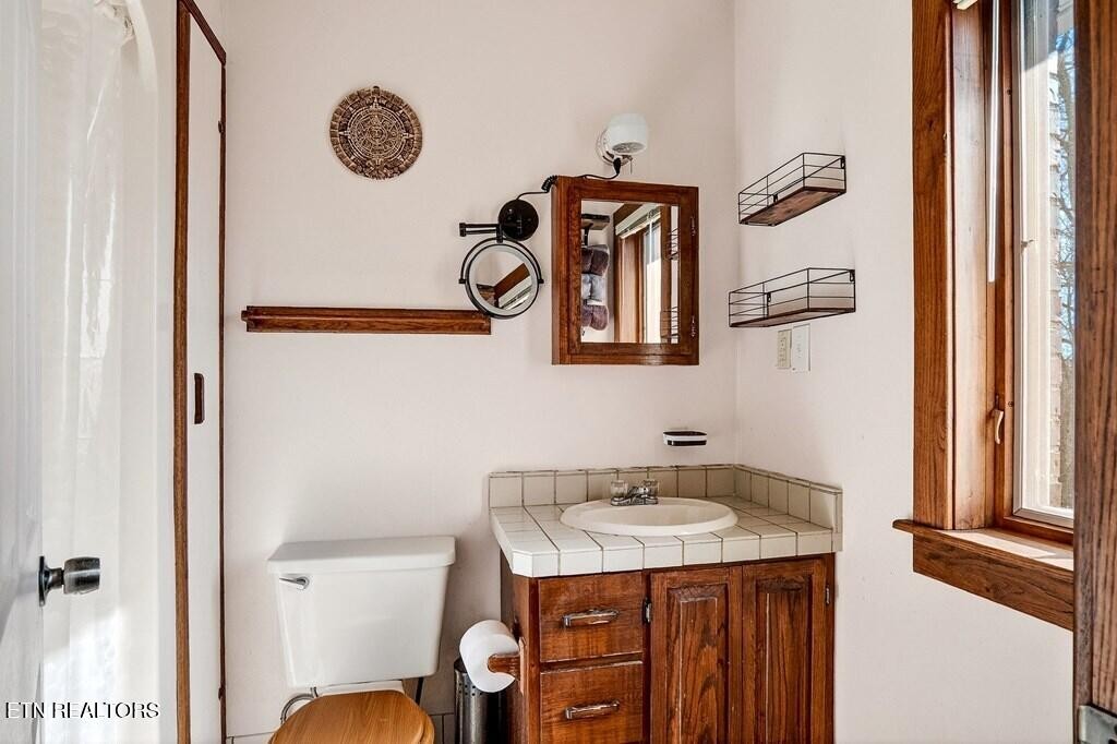 6211 Rocky Point Road Cookeville, TN 38506 - Photo 40 of 59 a bathroom with a sink and a mirror