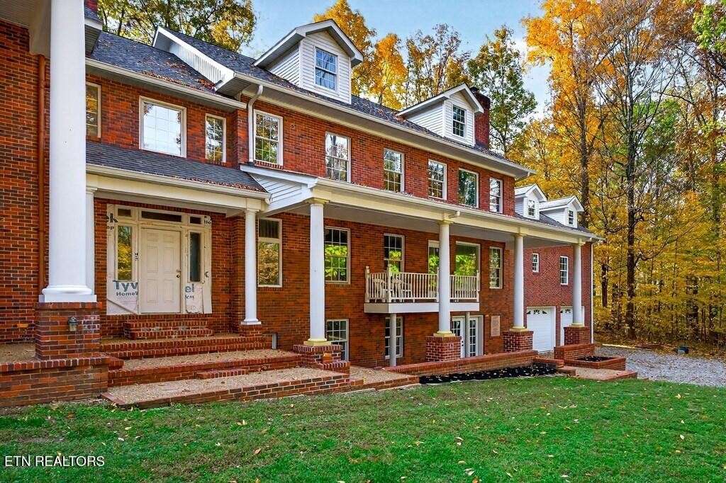 6211 Rocky Point Road Cookeville, TN 38506 - Photo 5 of 59 front view of a brick house with a yard