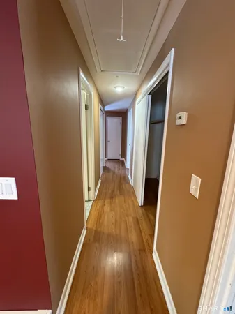 a view of a hallway with wooden floor