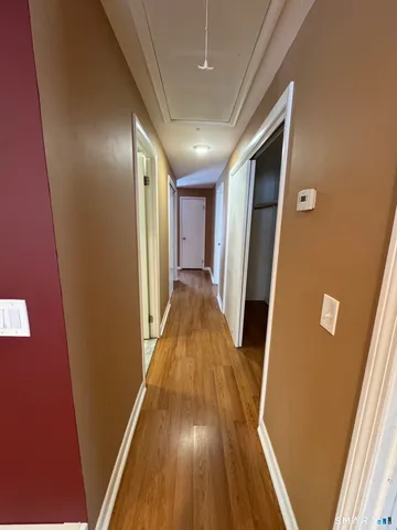 a view of a hallway with wooden floor