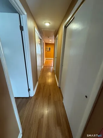 a view of a hallway with wooden floor