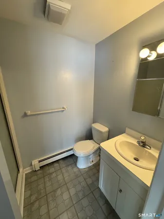 a bathroom with a sink a toilet and a mirror