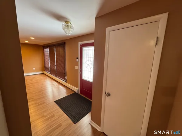 a view of a hallway with wooden floor