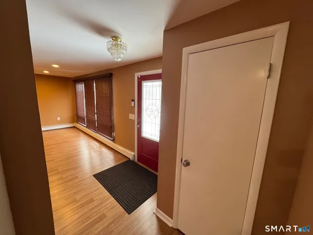a view of a hallway with wooden floor