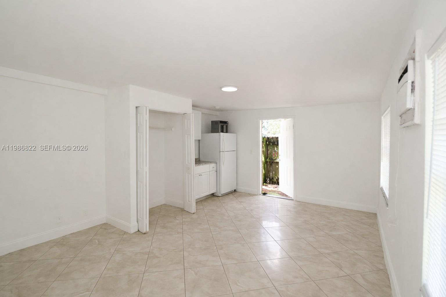 35 Virginia Road, Unit 1 West Park, FL 33023 - Photo 3 of 10 a view of empty room with a kitchen