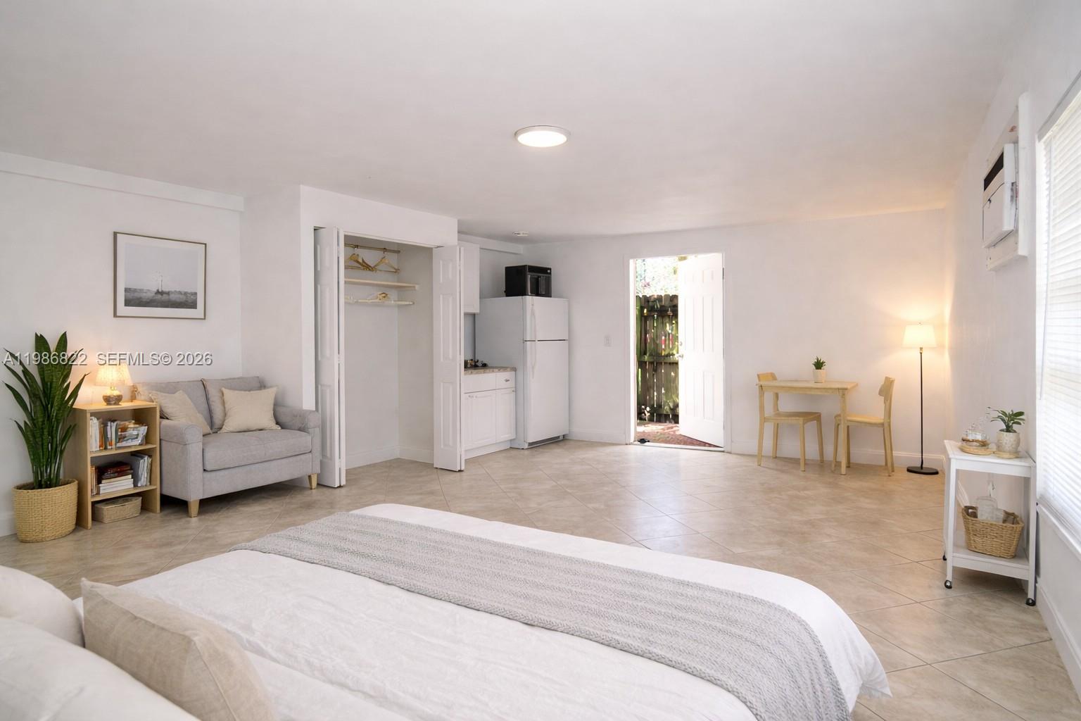 35 Virginia Road, Unit 1 West Park, FL 33023 - Photo 4 of 10 a spacious bedroom with a bed and a couch
