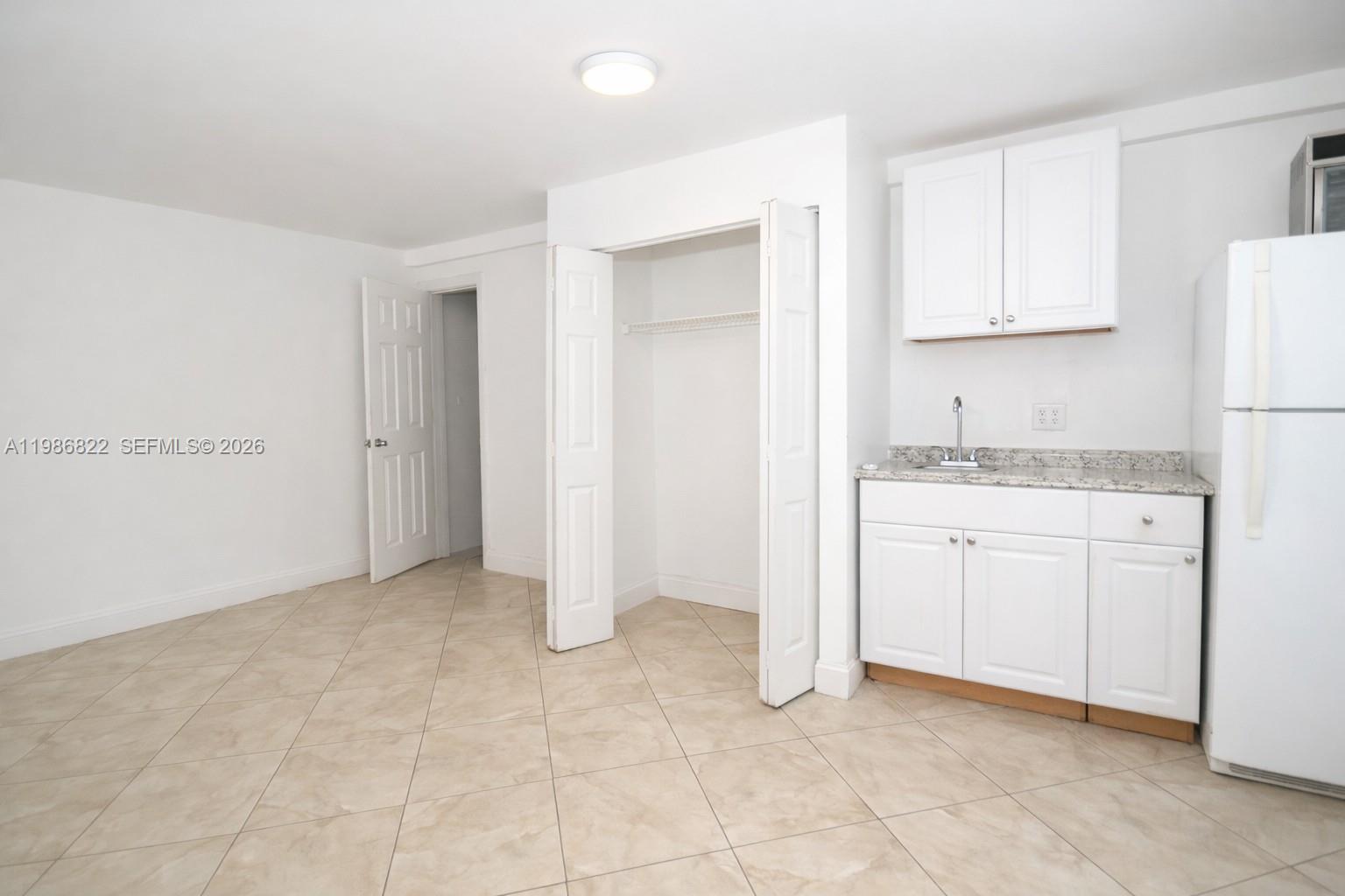 35 Virginia Road, Unit 1 West Park, FL 33023 - Photo 8 of 10 a view of kitchen with white cabinets