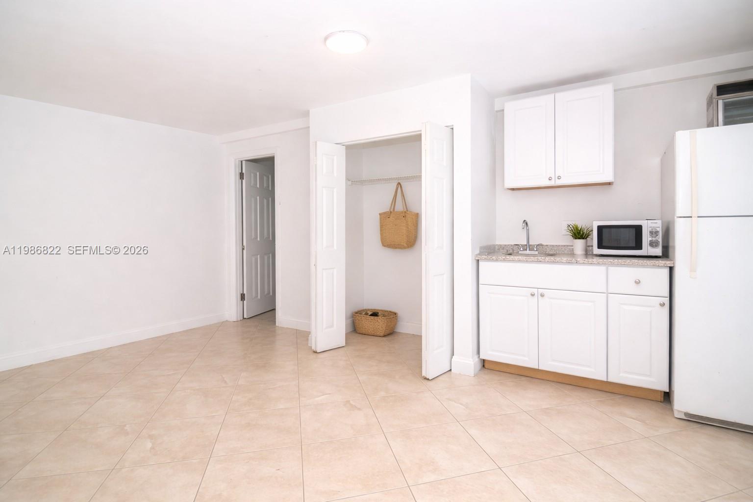 35 Virginia Road, Unit 1 West Park, FL 33023 - Photo 9 of 10 a view of a kitchen with white cabinets