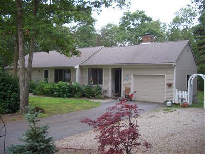 254 Winding Cove Road Marstons Mills, MA 02648 - Photo 1 of 1 a front view of a house with a garden and porch