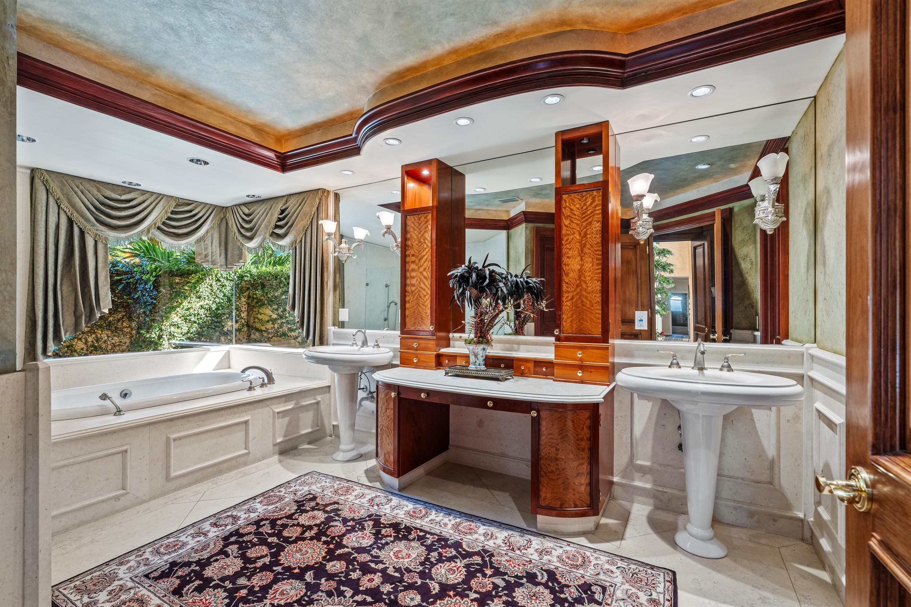 4475 Northwest 24th Terrace Boca Raton, FL 33431 - Photo 13 of 17 a bathroom with a sink a large mirror and a bathtub next to a window