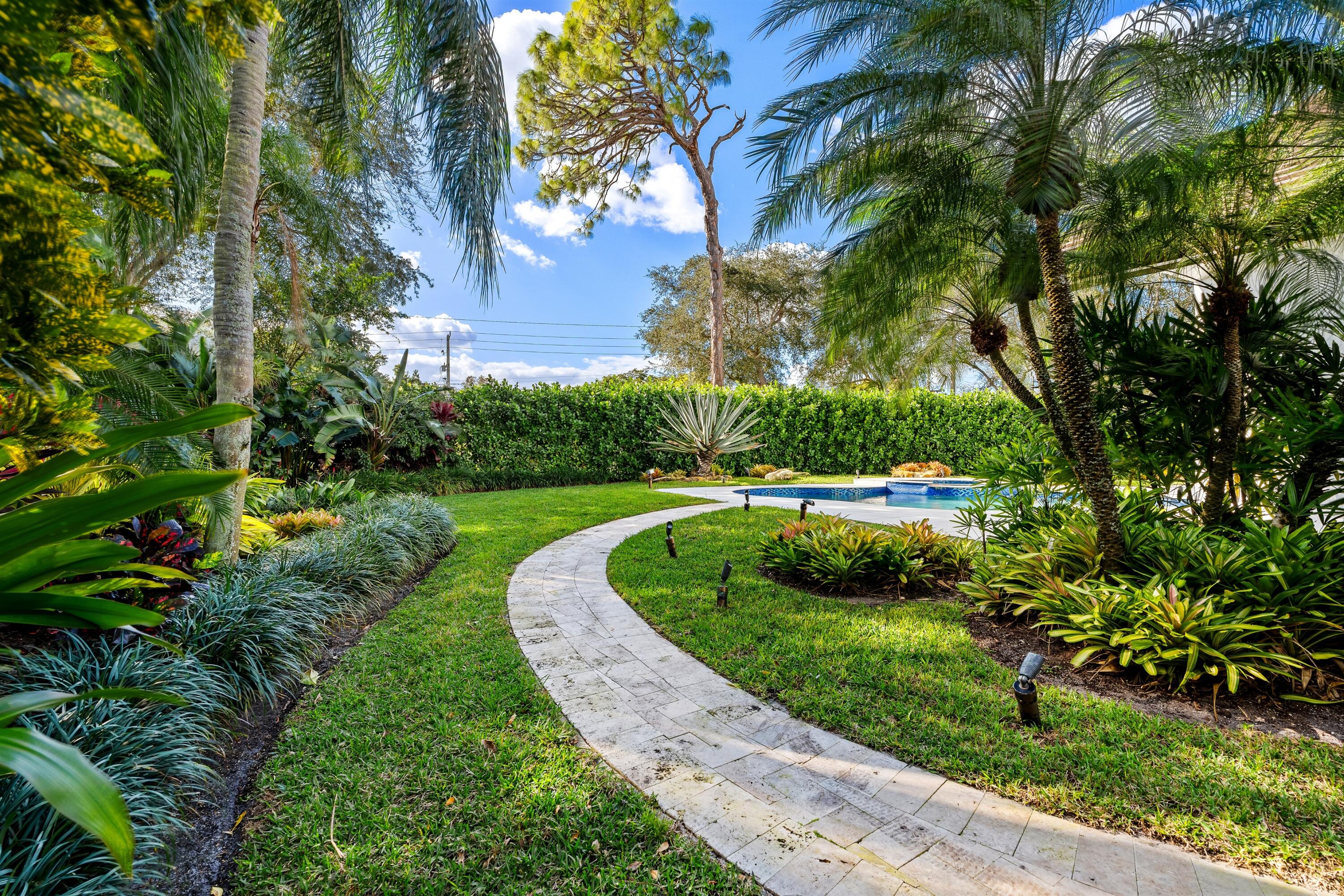 4475 Northwest 24th Terrace Boca Raton, FL 33431 - Photo 15 of 17 a view of a garden with plants and large trees