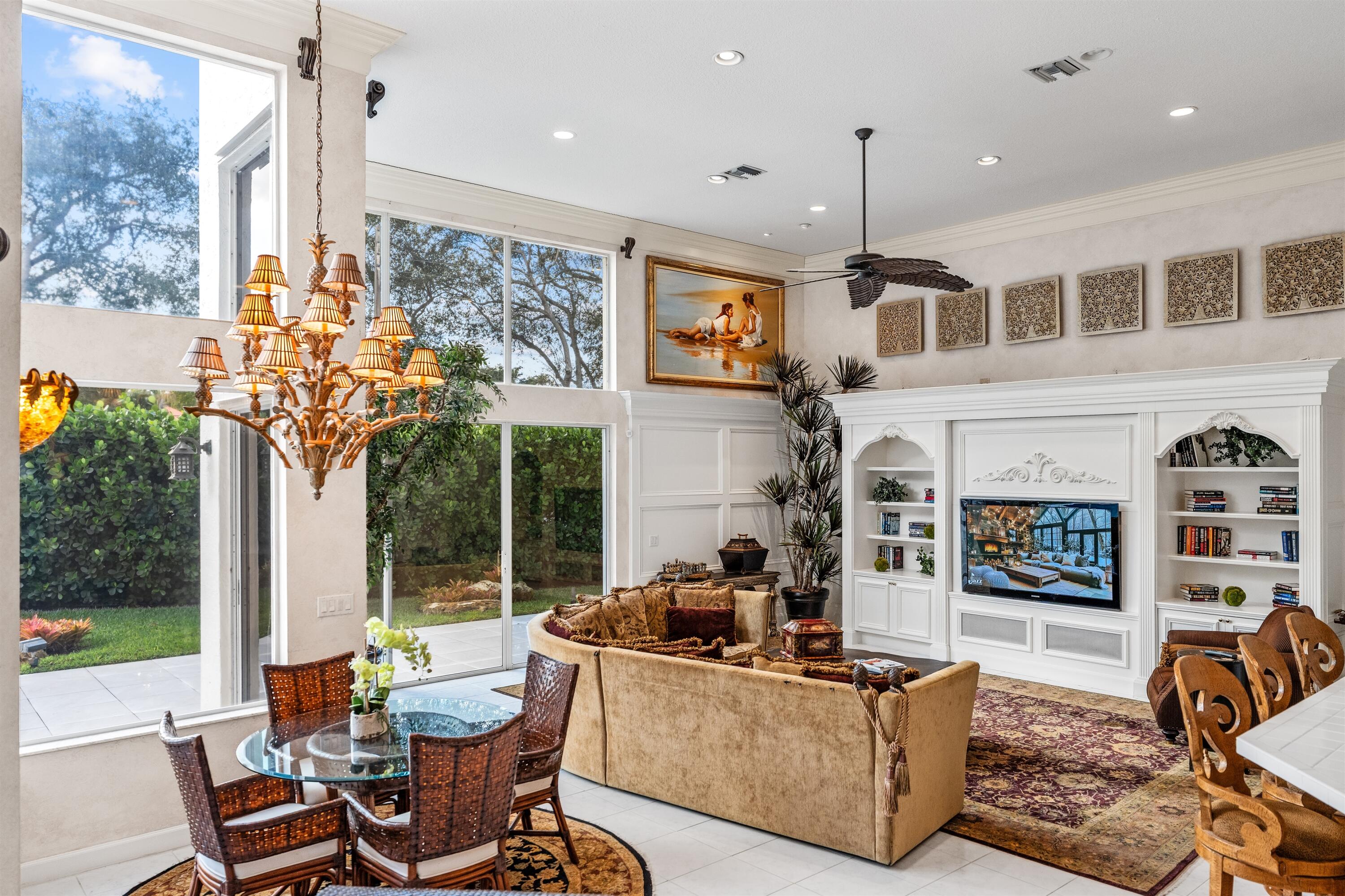 4475 Northwest 24th Terrace Boca Raton, FL 33431 - Photo 6 of 17 a living room with furniture a flat screen tv and a floor to ceiling window