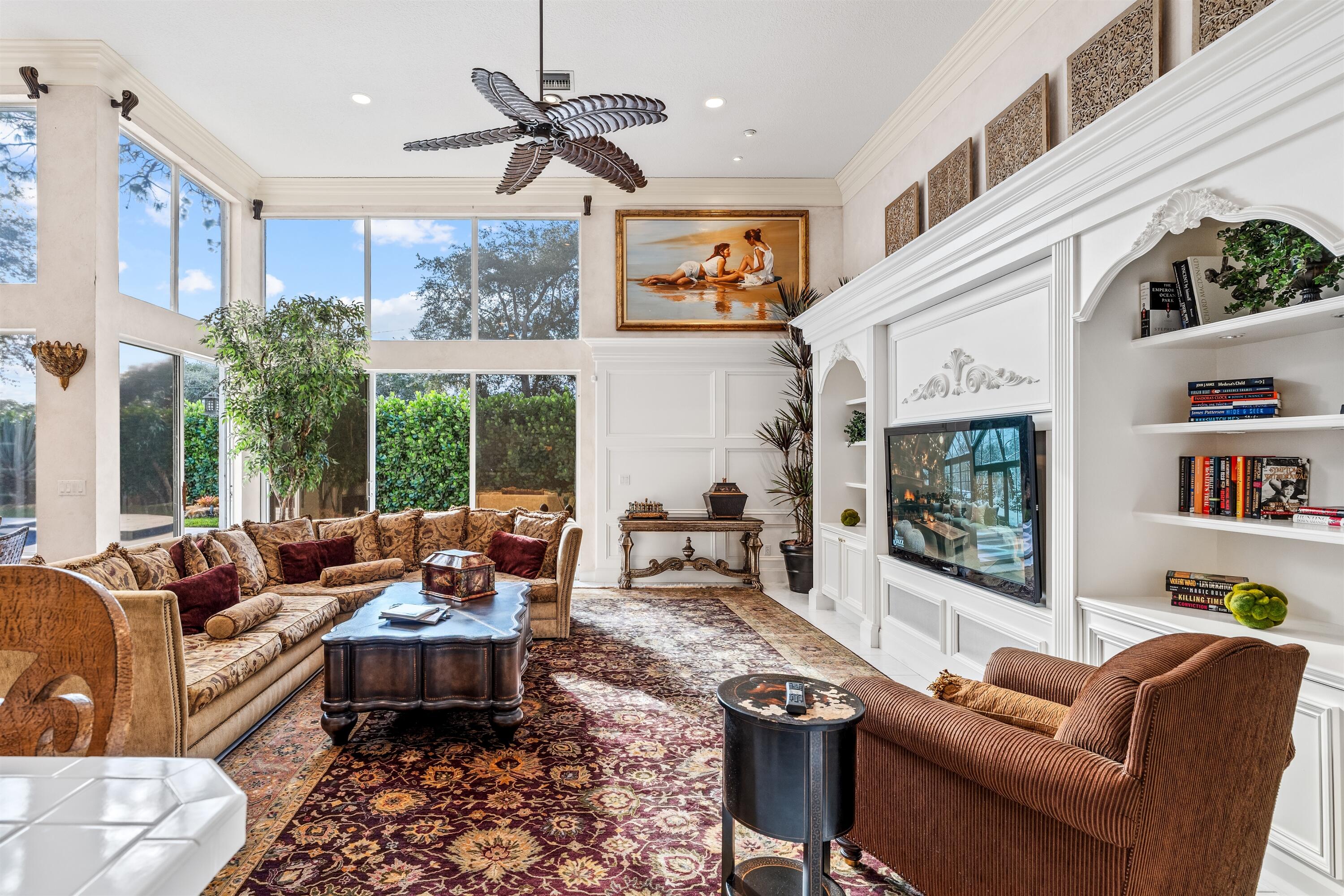 4475 Northwest 24th Terrace Boca Raton, FL 33431 - Photo 8 of 17 a living room with furniture a flat screen tv and a large window