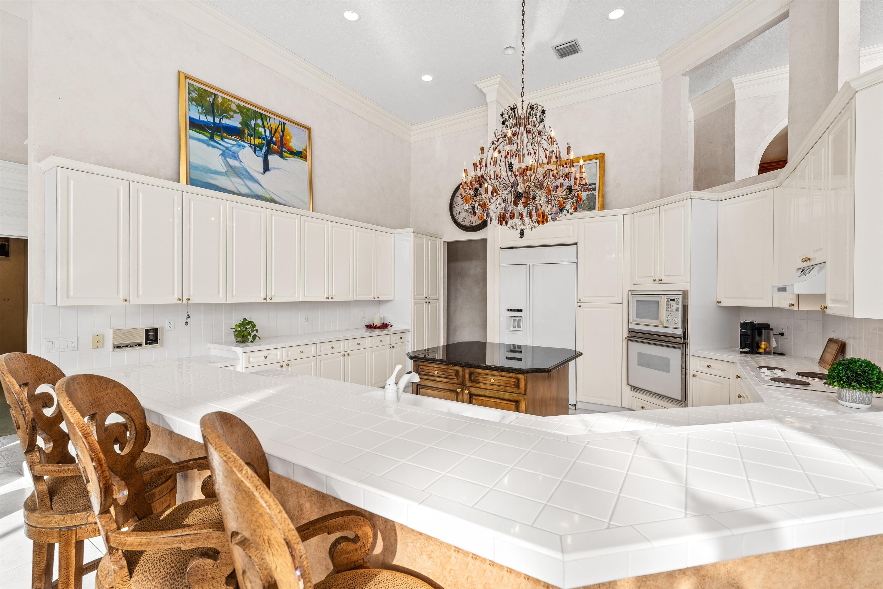 4475 Northwest 24th Terrace Boca Raton, FL 33431 - Photo 10 of 17 a kitchen with stainless steel appliances kitchen island granite countertop a sink and cabinets