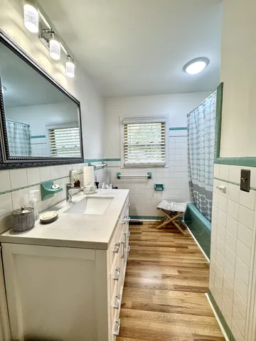 a spacious bathroom with a sink a mirror and a shower
