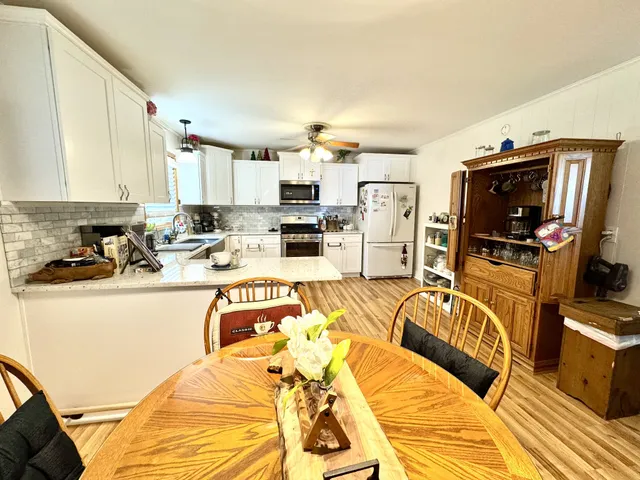 a view of a kitchen with sink and microwave