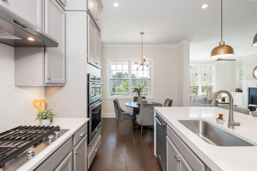 595 Hanlon Way Alpharetta, GA 30009 - Photo 11 of 33 a kitchen with sink stove and cabinets
