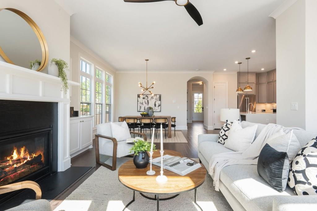 595 Hanlon Way Alpharetta, GA 30009 - Photo 13 of 33 a living room with furniture a fireplace and a chandelier