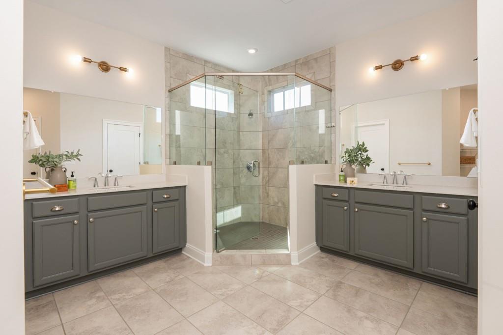 595 Hanlon Way Alpharetta, GA 30009 - Photo 19 of 33 a spacious bathroom with a shower sink and mirror