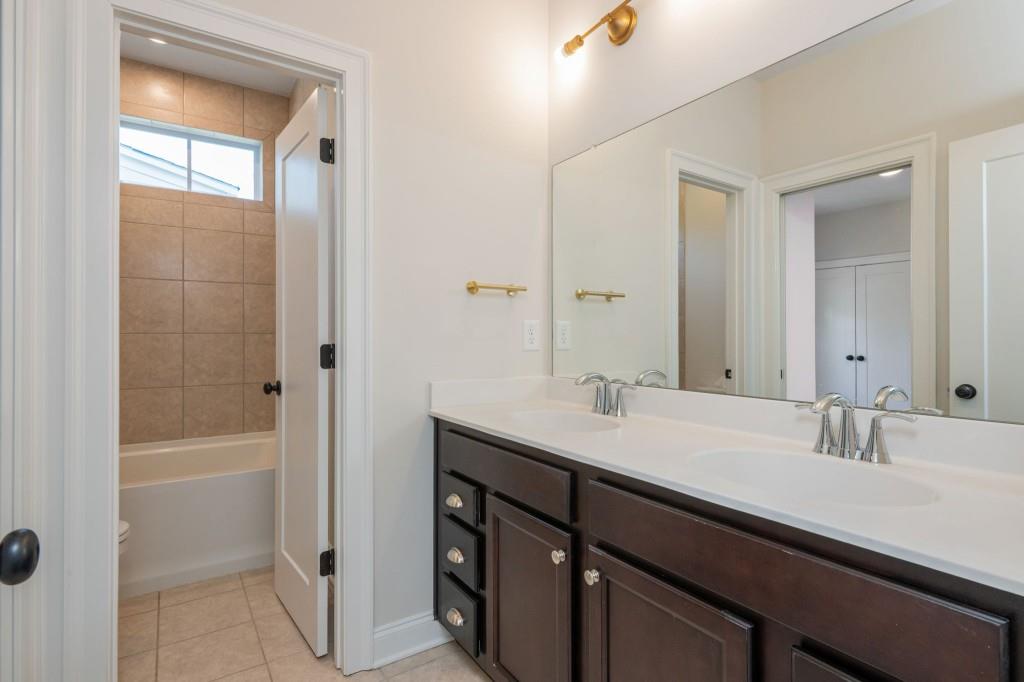 595 Hanlon Way Alpharetta, GA 30009 - Photo 20 of 33 a bathroom with a sink double vanity granite tub shower and a mirror