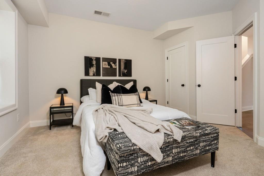 595 Hanlon Way Alpharetta, GA 30009 - Photo 24 of 33 a bedroom with a bed and chair