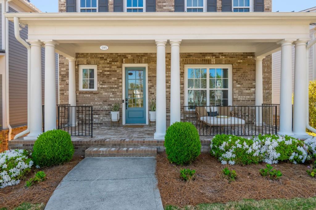 595 Hanlon Way Alpharetta, GA 30009 - Photo 3 of 33 a front view of a house with a yard and plants