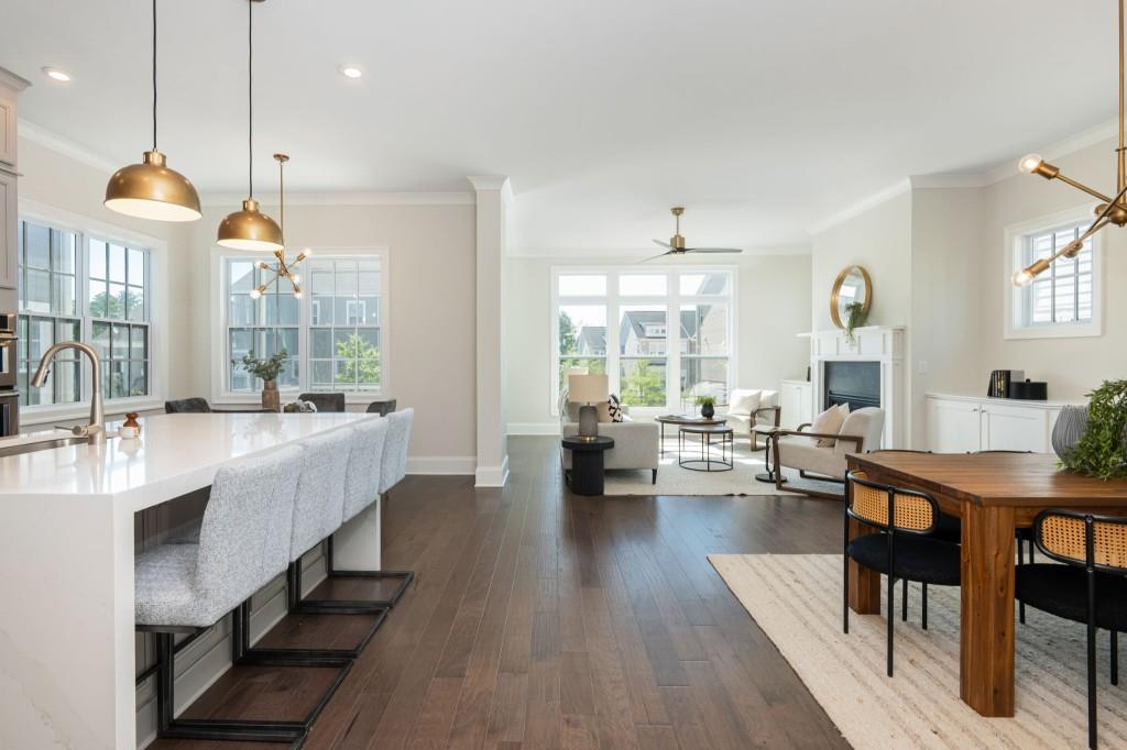 595 Hanlon Way Alpharetta, GA 30009 - Photo 6 of 33 a very nice looking living room with a dining table wooden floor and a chandelier