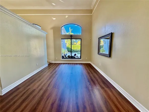 a living room with furniture and large windows