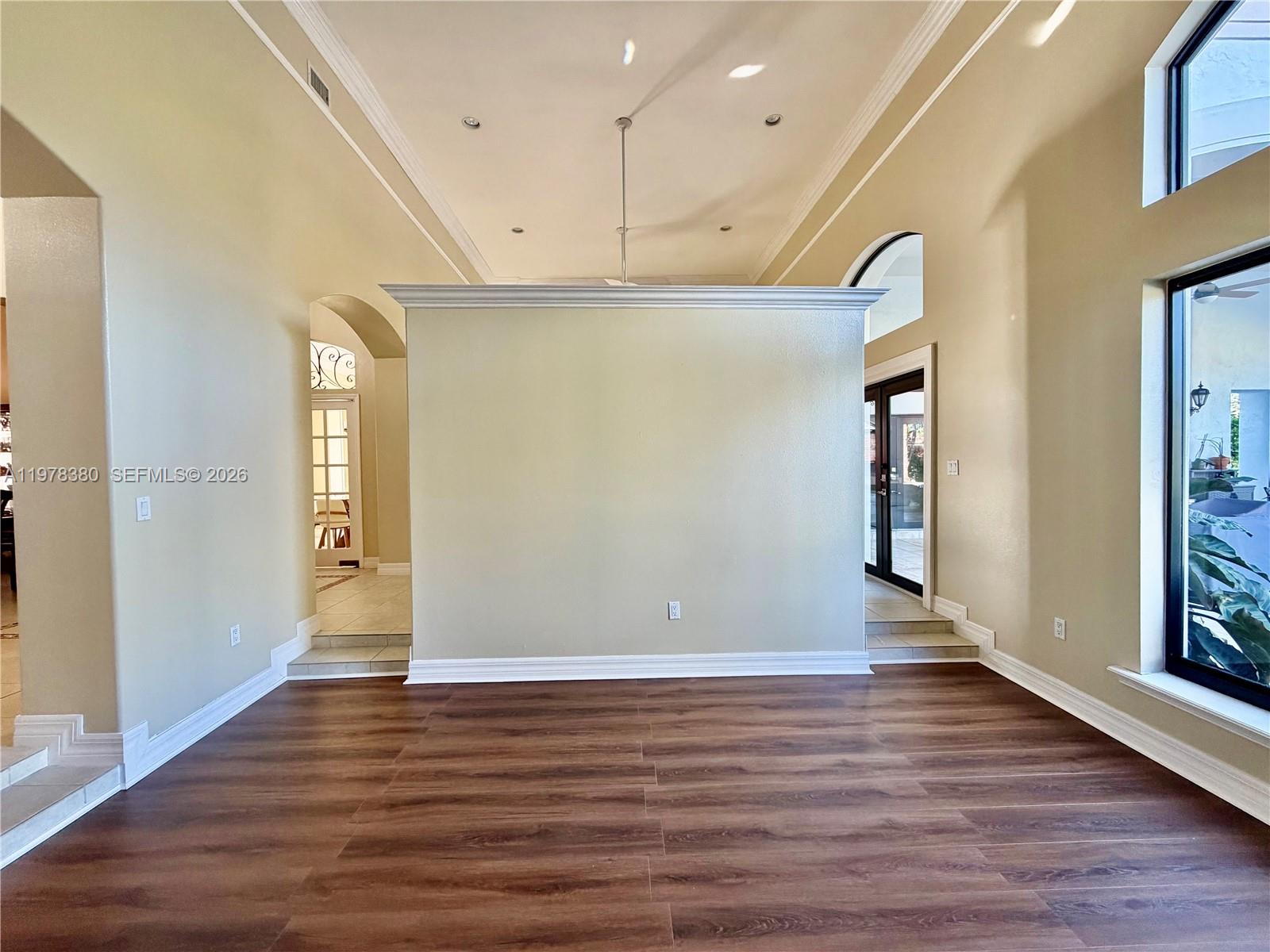 12391 Southwest 75th Street Miami, FL 33183 - Photo 15 of 89 a view of an empty room with wooden floor and a window