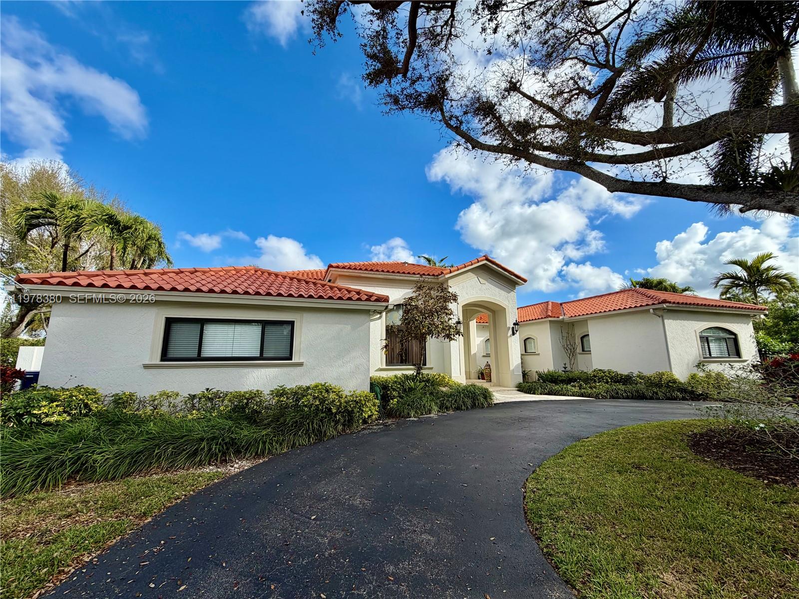 12391 Southwest 75th Street Miami, FL 33183 - Photo 2 of 89 a front view of a house with a yard