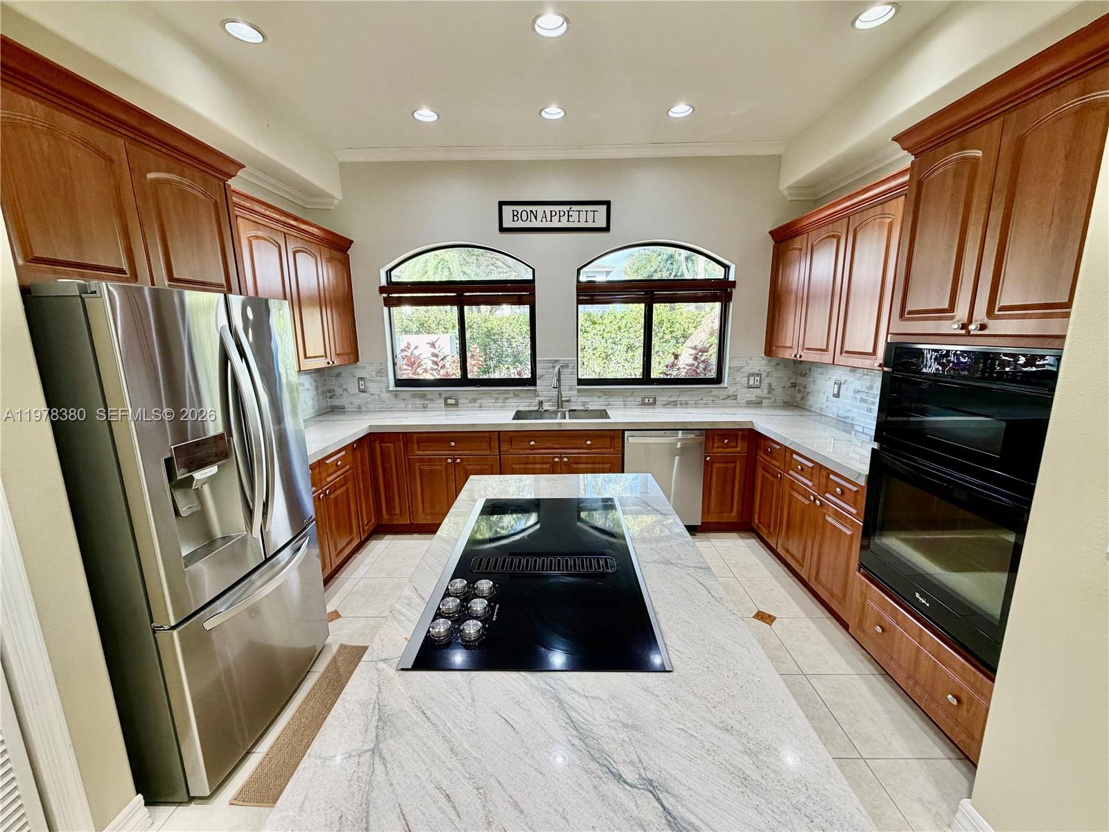 12391 Southwest 75th Street Miami, FL 33183 - Photo 27 of 89 a kitchen with stainless steel appliances granite countertop a refrigerator a sink dishwasher and wooden cabinets