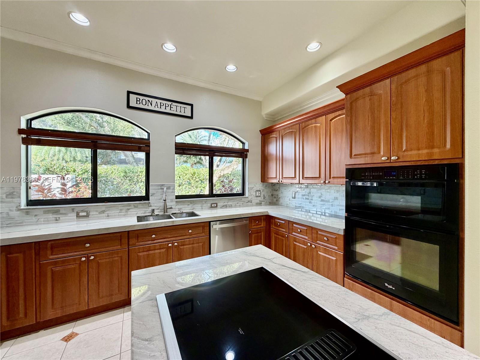 12391 Southwest 75th Street Miami, FL 33183 - Photo 28 of 89 a kitchen with stainless steel appliances wooden cabinets stove and a sink