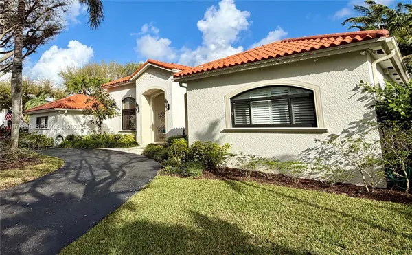 a front view of a house with a garden
