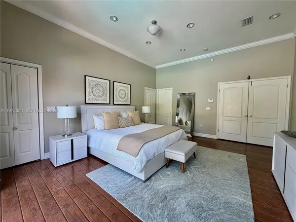a bedroom with a bed window and a flat screen television