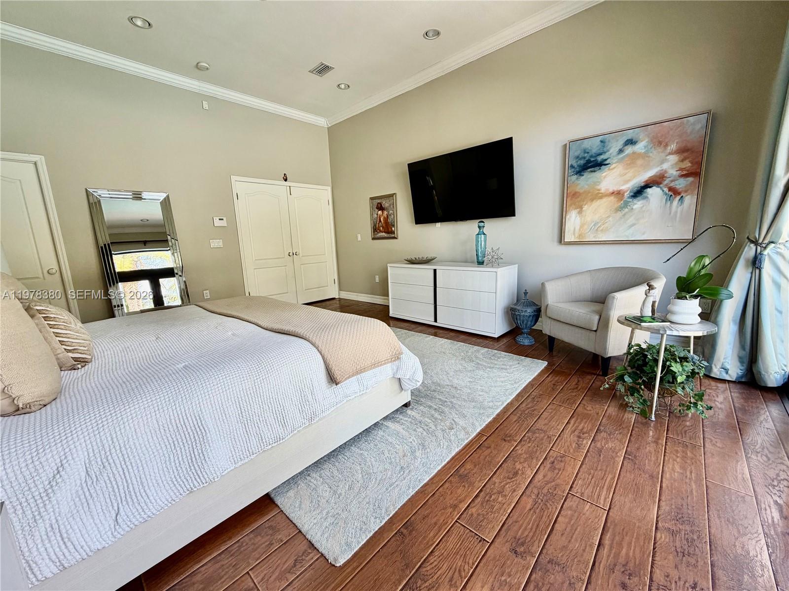 12391 Southwest 75th Street Miami, FL 33183 - Photo 40 of 89 a spacious bedroom with a bed and a flat screen tv