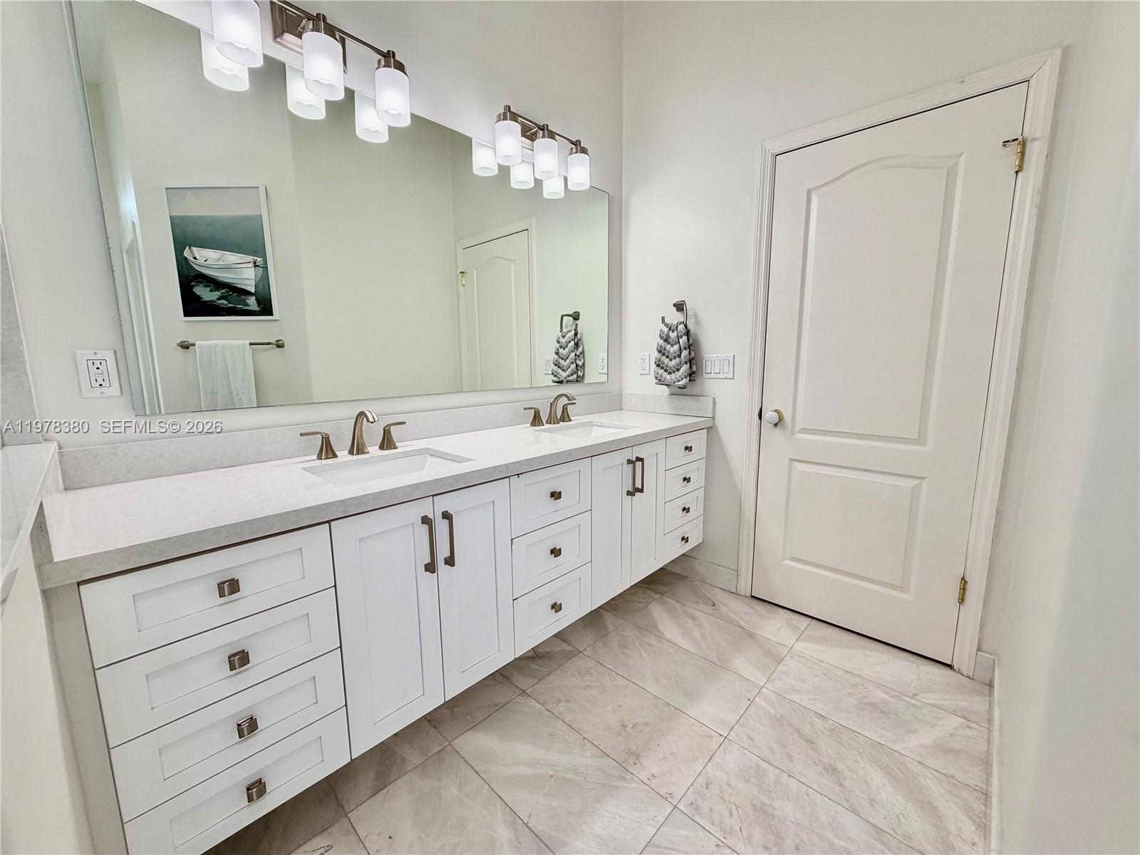 12391 Southwest 75th Street Miami, FL 33183 - Photo 44 of 89 a bathroom with a double vanity sink mirror and