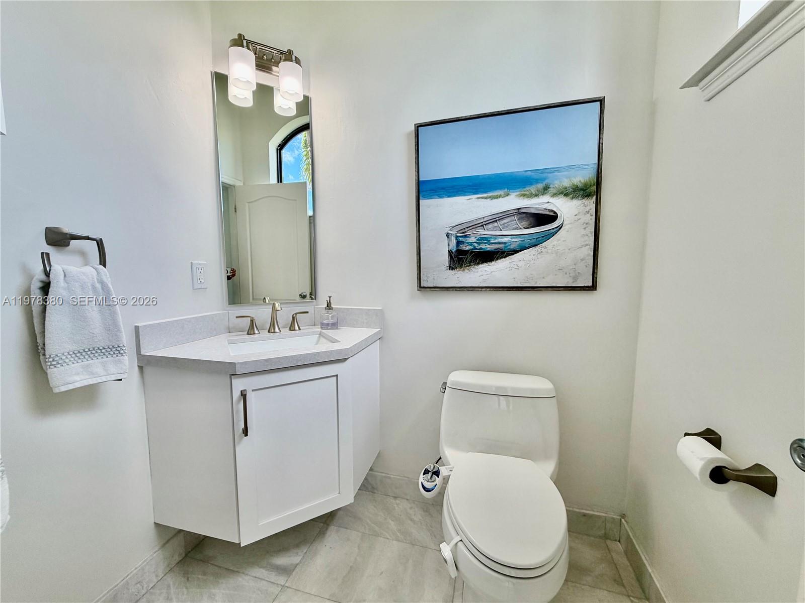 12391 Southwest 75th Street Miami, FL 33183 - Photo 45 of 89 a bathroom with a toilet sink and mirror