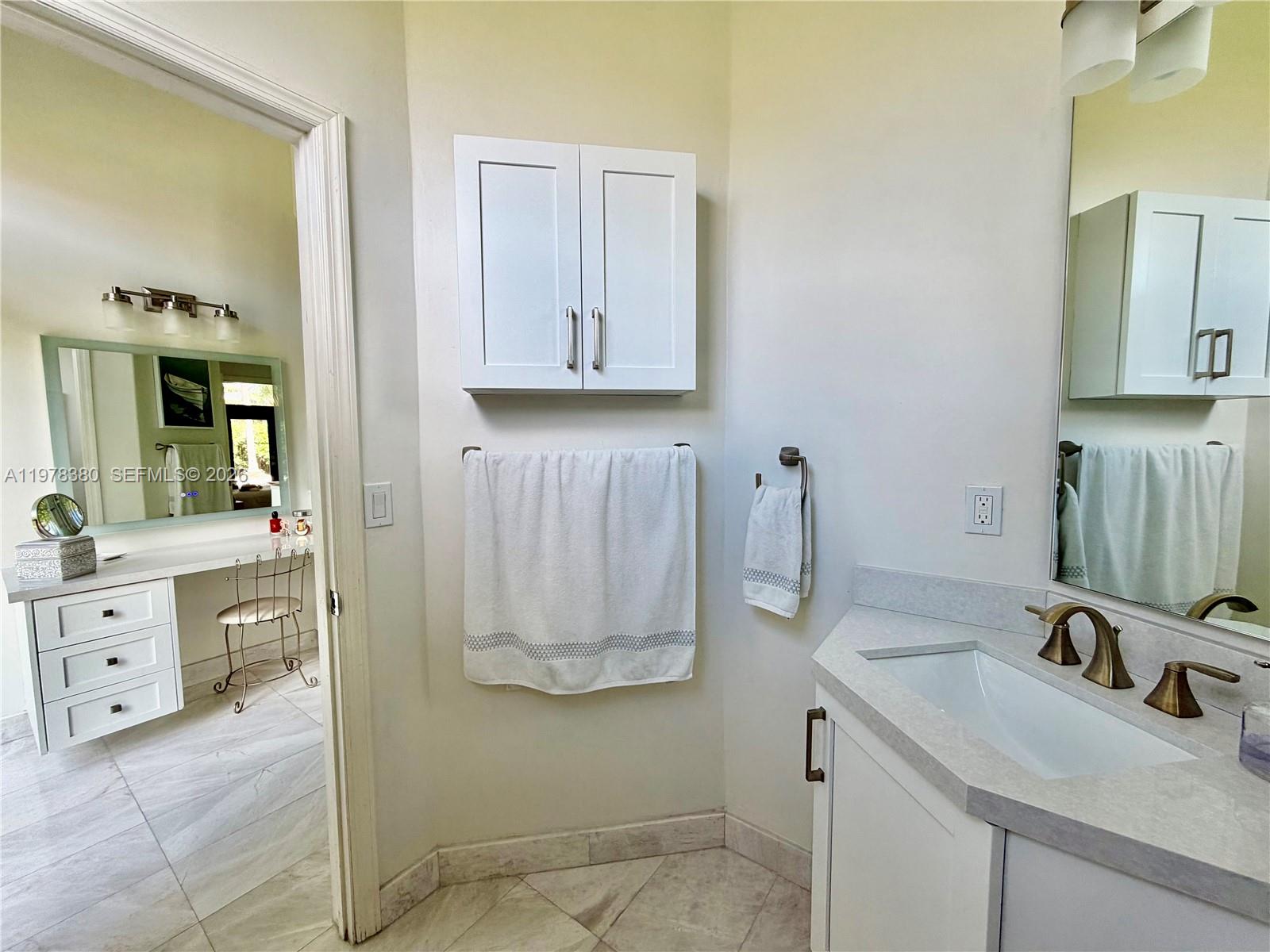 12391 Southwest 75th Street Miami, FL 33183 - Photo 46 of 89 a bathroom with a sink and a mirror