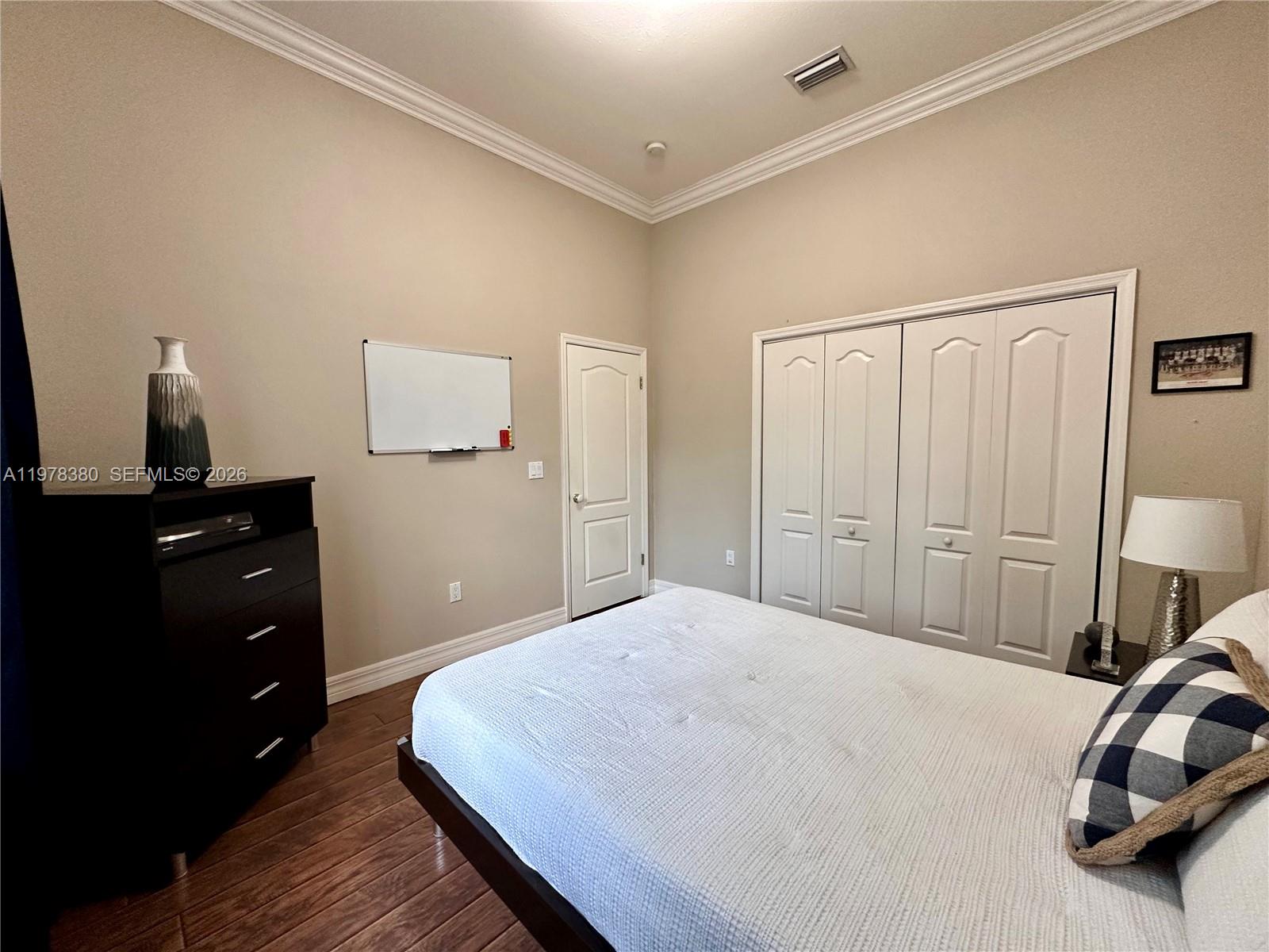 12391 Southwest 75th Street Miami, FL 33183 - Photo 49 of 89 a bedroom with a bed and a dresser