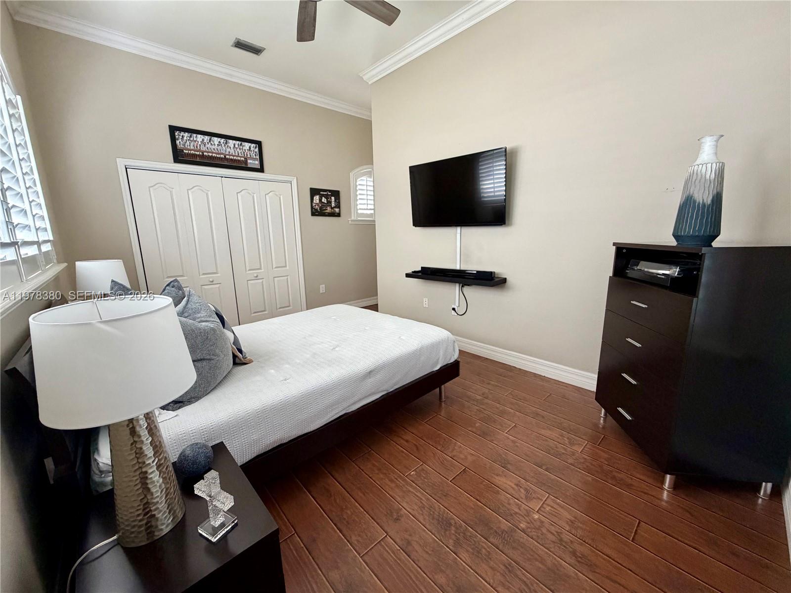 12391 Southwest 75th Street Miami, FL 33183 - Photo 59 of 89 a living room with furniture and a flat screen tv
