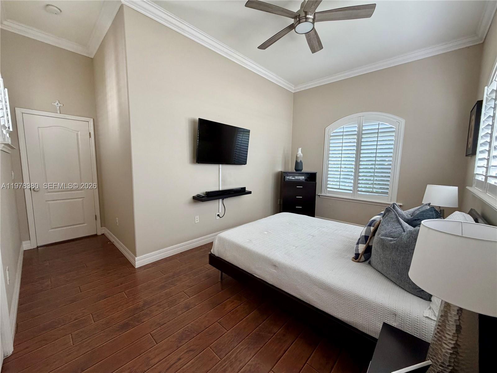 12391 Southwest 75th Street Miami, FL 33183 - Photo 60 of 89 a bedroom with a bed window and a flat screen television