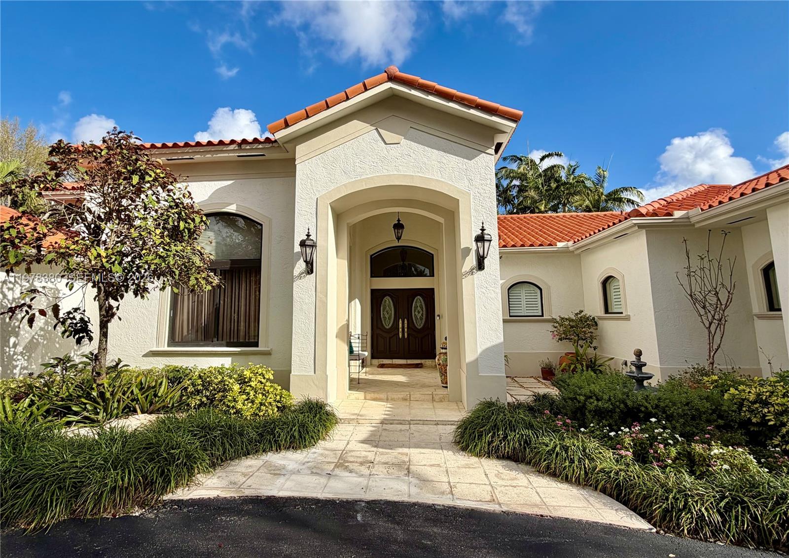 12391 Southwest 75th Street Miami, FL 33183 - Photo 6 of 89 a front view of a house with a garden
