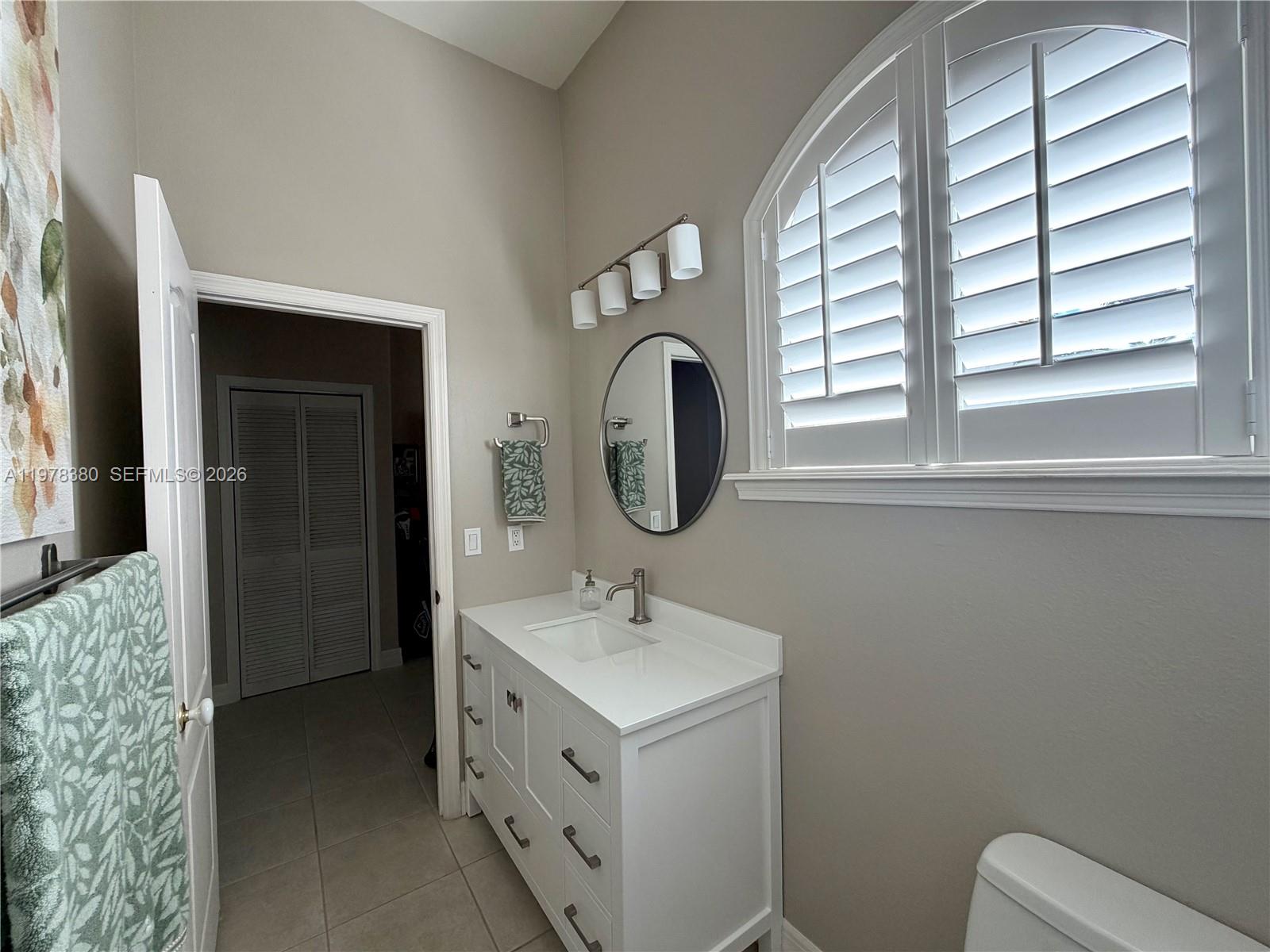 12391 Southwest 75th Street Miami, FL 33183 - Photo 64 of 89 a bathroom with a toilet sink and mirror