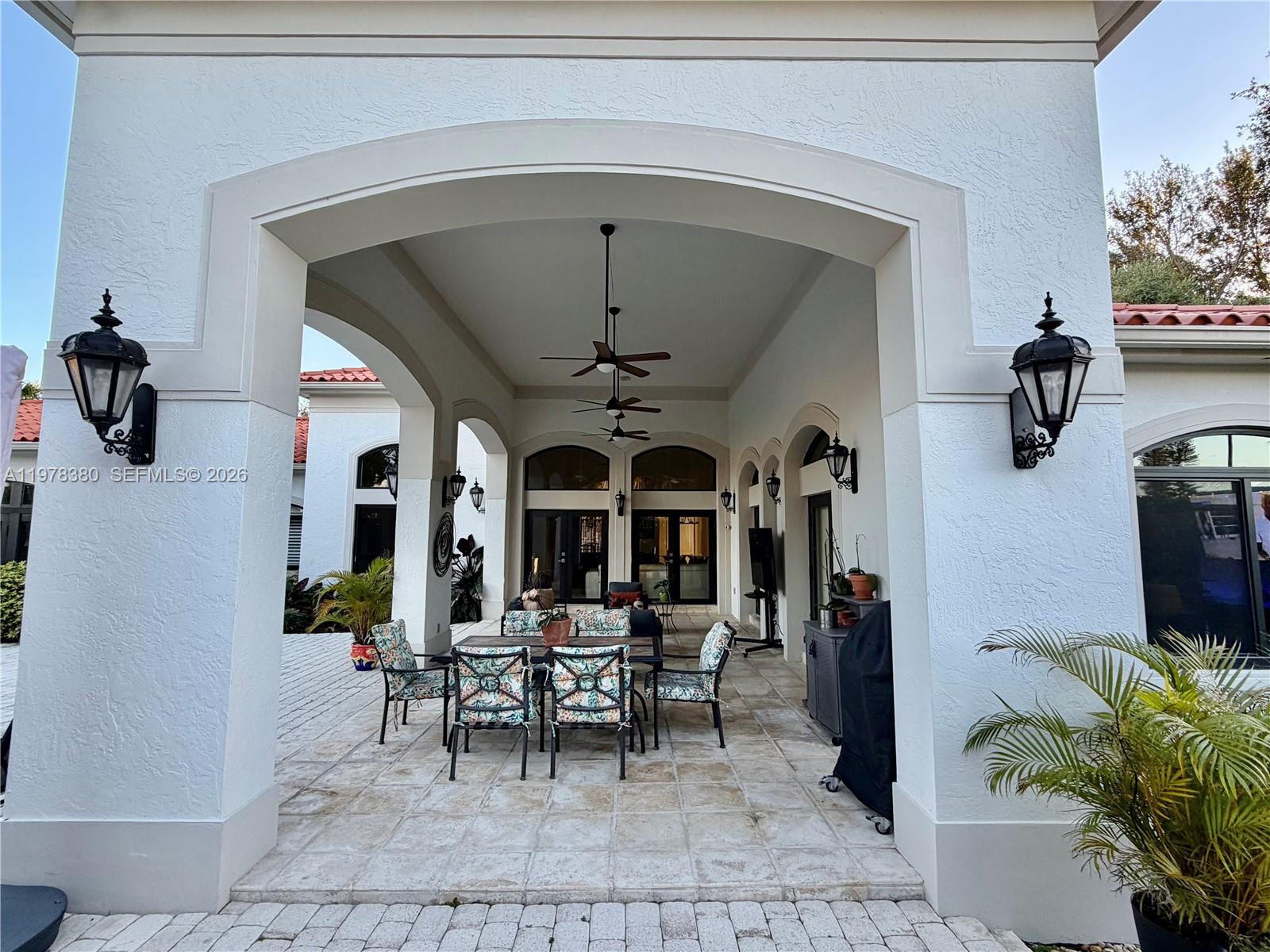 12391 Southwest 75th Street Miami, FL 33183 - Photo 77 of 89 a view of a dining room with furniture and chandelier