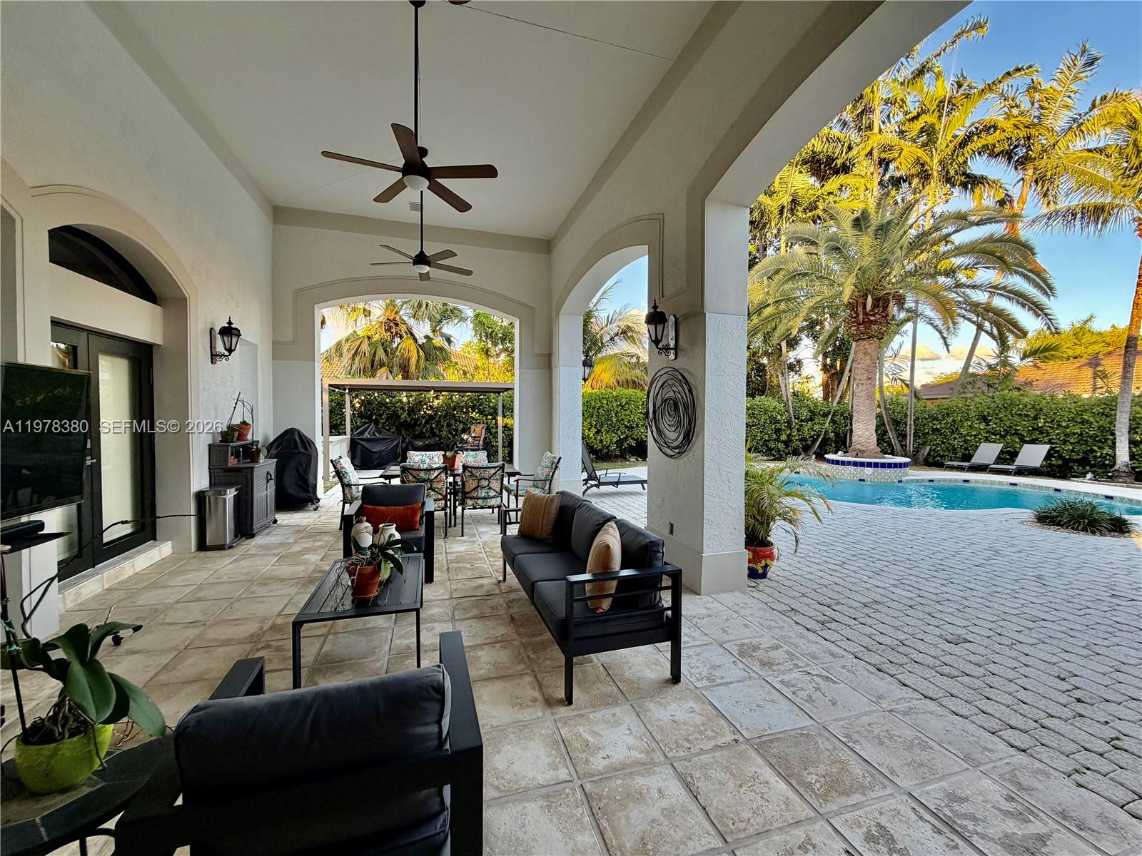 12391 Southwest 75th Street Miami, FL 33183 - Photo 79 of 89 a living room with patio furniture and a large window