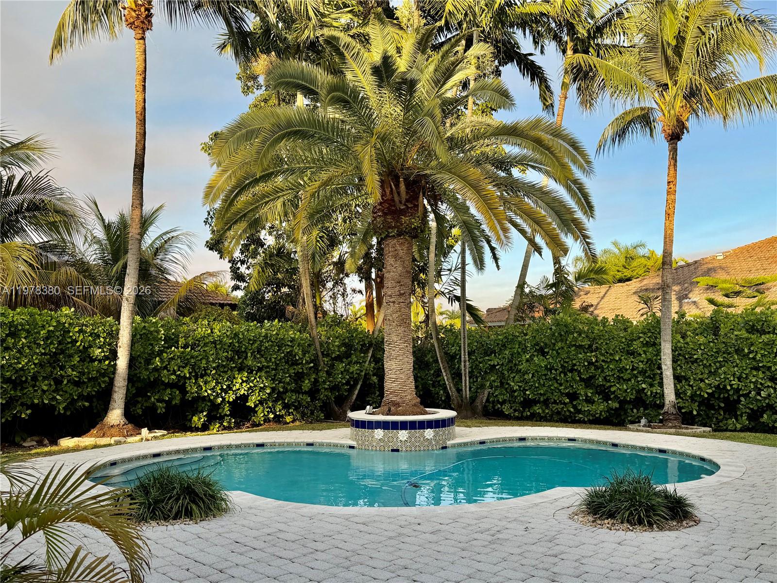 12391 Southwest 75th Street Miami, FL 33183 - Photo 80 of 89 a view of a swimming pool with a garden
