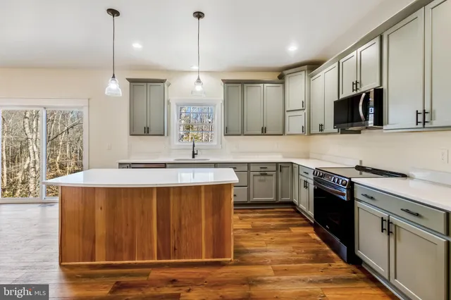 a view of a room with wooden floor