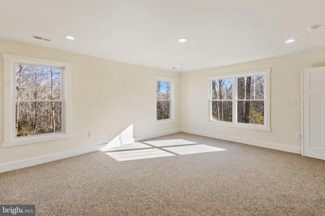 a kitchen with a table chairs refrigerator and cabinets