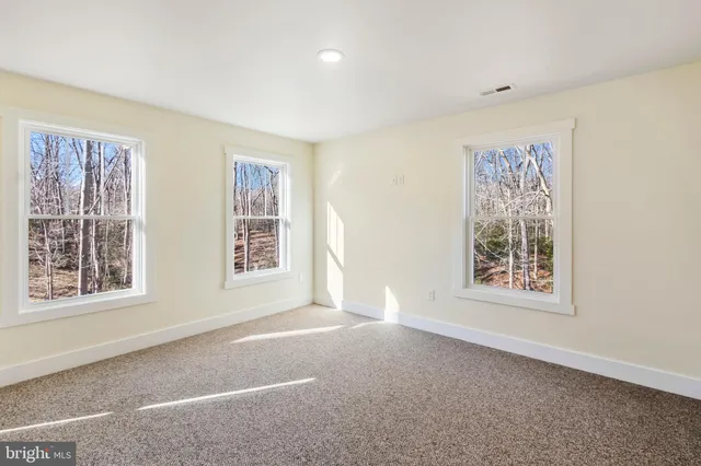 a bathroom with a granite countertop sink toilet a mirror and shower